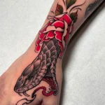 Tatouage de serpent et de rose sur la main – Jake Tattoo Parlor à Belfort.